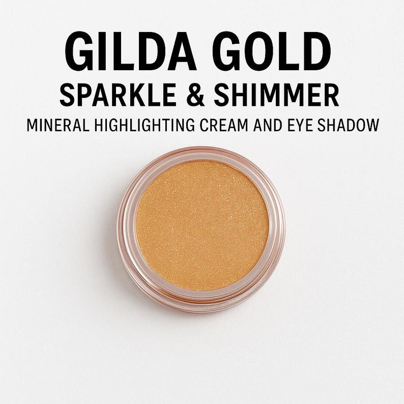 May include: A small round container of Gilda Gold Sparkle & Shimmer mineral highlighting cream and eye shadow. The cream is a shimmery gold color.