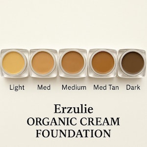 May include: Five small jars of foundation in shades of light, medium, medium tan, and dark. The jars are labeled with the shades and the text "Erzulie ORGANIC CREAM FOUNDATION".
