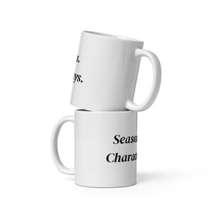 May include: Two white ceramic mugs stacked on top of each other. The top mug has the text "...ways." The bottom mug has the text "Season Character."