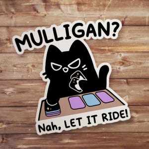 May include: A die-cut sticker featuring a black cat with white eyes holding playing cards at a table with three cards laid out. The text MULLIGAN? is arched above the cat, and the text Nah, LET IT RIDE! is printed in black at the bottom.