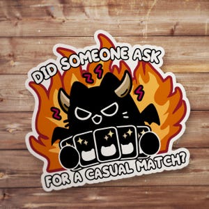May include: A die-cut sticker featuring a black cat with horns and wings, surrounded by orange and yellow flames. The cat holds a hand of playing cards. The text reads DID SOMEONE ASK FOR A CASUAL MATCH? in bold white letters with a black outline.