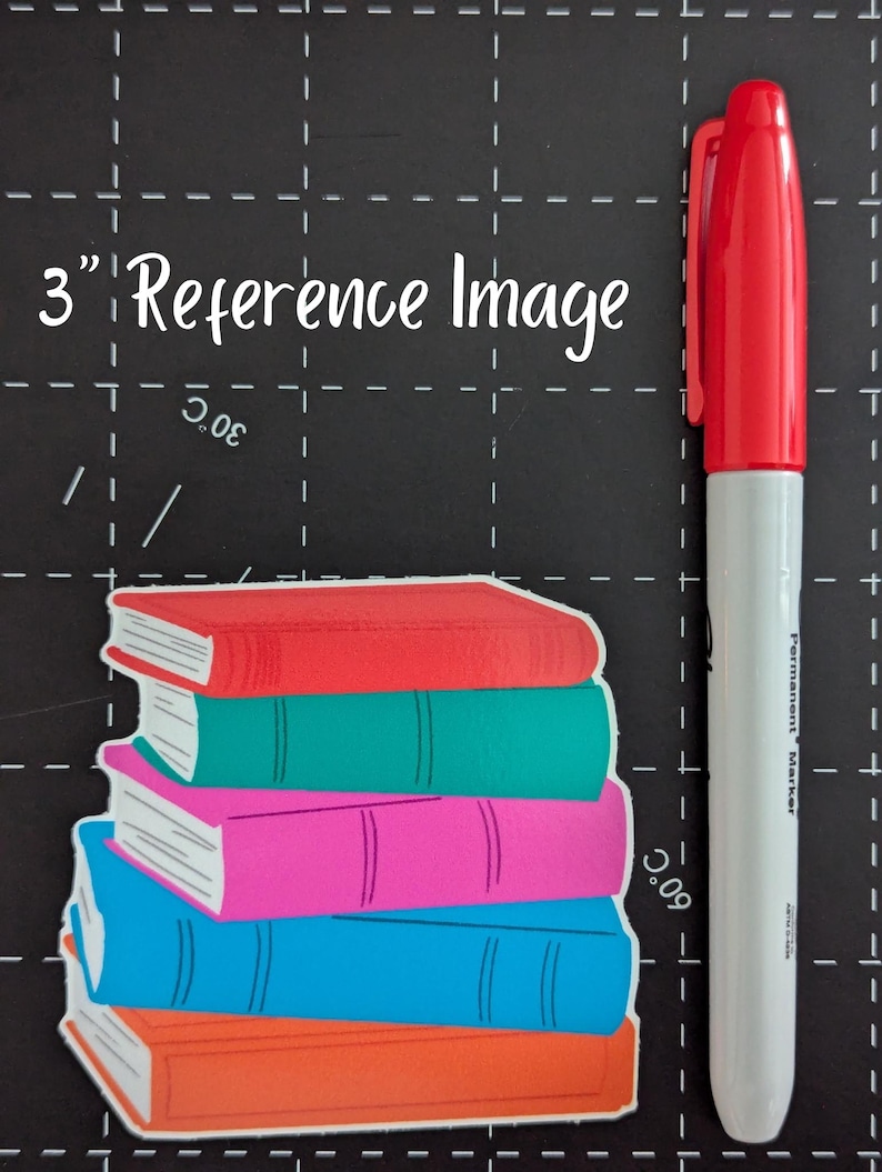 May include: A stack of colorful book stickers with red, green, pink, blue, and orange covers. A red and white permanent marker, approximately 6 inches long, is positioned next to the books. The text "3" Reference Image" is visible.