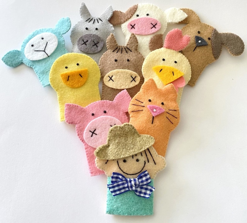 May include: Set of ten felt finger puppets featuring various farm animals, including a cow, pig, sheep, chicken, duck, horse, cat, dog, and a farmer. The puppets are all brightly colored and have friendly faces.