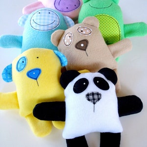 May include: A set of six plush toys, each with a different animal design. The toys are made of soft, colorful fabric and have embroidered details. The animals include a pig, a frog, a bear, a panda, a dog, and a bunny.