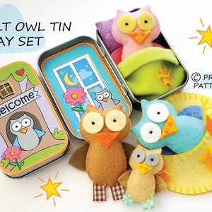 May include: Felt owl play set in a tin with a welcome sign, a sleeping owl, a flying owl, and a baby owl. The tin has a window with a moon and stars.