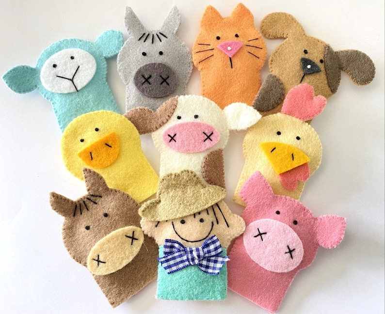 May include: Set of ten felt finger puppets featuring farm animals, including a cow, pig, horse, duck, chicken, sheep, dog, cat, and a farmer. The puppets are all brightly colored and have friendly faces.
