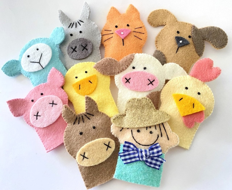 May include: Set of ten felt finger puppets featuring various animals, including a pig, cow, chicken, horse, and a farmer. The puppets are brightly colored and have embroidered details.