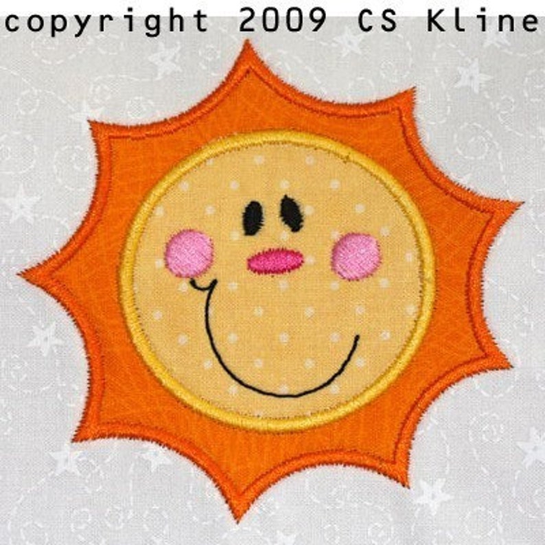 May include: A smiling yellow sun with a orange outline and white polka dots. The sun has black eyes, a pink nose, and pink cheeks.