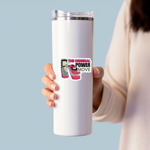 May include: A white insulated tumbler with a sticker featuring two retro cell phones and the text "THE ORIGINAL POWER MOVE" in pink and black. The tumbler is held by a person.