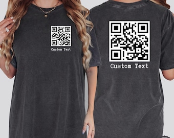 May include: Two black t-shirts with a white QR code and the text "Custom Text" printed on them.