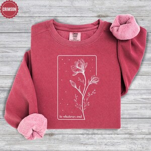May include: Crimson red sweatshirt with a white floral design and the text "to whatever end".