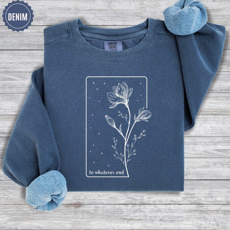 May include: A dark blue sweatshirt with a white outline of a flower and the text "to whatever end".