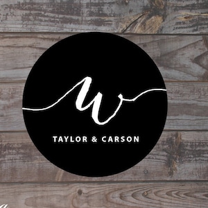 May include: Black and white logo design with the letters "W" in a circle. The text "Taylor & Carson" is below the circle.