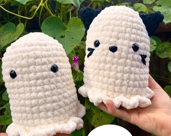 May include: Two white crochet ghost plushies with black eyes and accents, held in hands. One ghost has black ears. The image includes the text "CROCHET PATTERN" and "PDF Pattern Only".