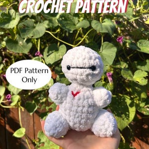 May include: A white crocheted plush toy with a red heart and black eyes is held in a hand. The text "CROCHET PATTERN" is at the top, and "PDF Pattern Only" is in a circle. The text "Made by @GetHookedbyJules" is at the bottom.