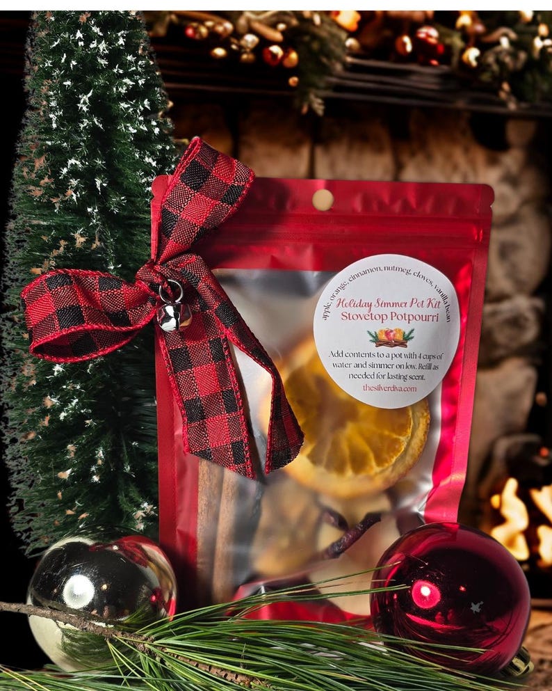 Christmas stovetop, potpourri.
And holiday winter simmer pot kit.
In a red package with a christmas bow in the corner with a silver jingle bell charm.