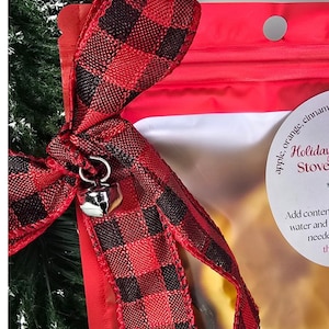 Red and black plaid bow with silver jingle bell charm on a simmer pot bag.