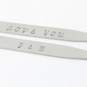 Stainless steel collar stays say I love you on one and initials on the other. These are personalized with any text you would like.