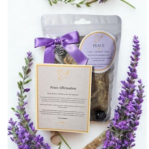 May include: A clear pouch with a purple bow and a silver charm, containing a simmer pot with the text "PEACE". A card with the text "Peace Affirmation" and a dove illustration is also present. Lavender sprigs frame the items.