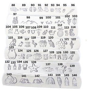May include: A set of 146 silver metal stamp charms with various designs, including animals, plants, objects, and symbols. The charms are arranged in rows, numbered from 88 to 146.