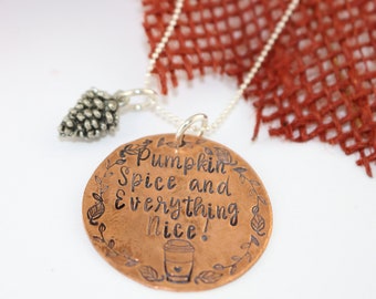 May include: Copper necklace with a silver pine cone charm and a round copper pendant with the text "Pumpkin Spice and Everything Nice!" and a small coffee cup graphic.