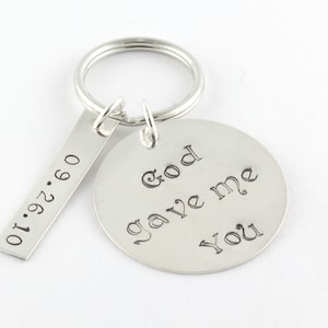 May include: Silver keychain with a round tag that says "God gave me you" and a rectangular tag with the date "01.27.09".