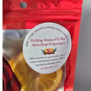 Holiday simmer pot kit white label on a red bag.