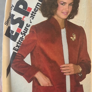 May include: A vintage sewing pattern for a red corduroy jacket with a mandarin collar and a zipper closure. The pattern is called "Extra-Sure pattern" and is priced at 95 cents.
