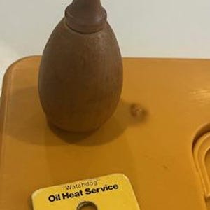 May include: A yellow plastic dog training tool with a wooden mallet. The tool has a cutout for a dog's paw and the text "Cat Pawl Safety First" printed on it.