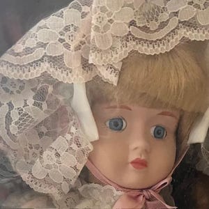 A connoisseur collection doll from Seymour Mann MCMXCVI Hand painted porcelain head, arms, and legs