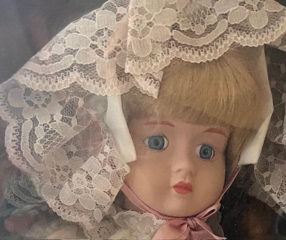 A connoisseur collection doll from Seymour Mann MCMXCVI Hand painted porcelain head, arms, and legs