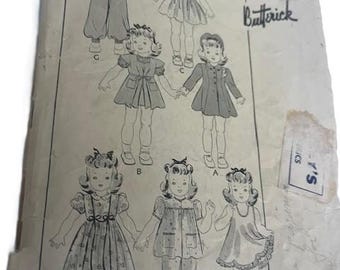 May include: Vintage Butterick doll clothing pattern. The pattern features illustrations of various doll outfits, including dresses, coats, and pajamas. The doll length is 16 inches. The pattern is printed on aged paper with visible wear and tear.