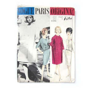 May include: Vintage Vogue Paris Original sewing pattern number 1104 designed by Patou. The pattern features four women wearing different styles of coats. The coats are white, blue, red, and cream.
