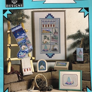 May include: A cross-stitch pattern booklet for a "Silent Night" design. The cover features a variety of cross-stitch projects, including a stocking, a wall hanging, and a small box. The booklet is part of the "Reflections of the High Desert" series, designed by Jan Hunt.