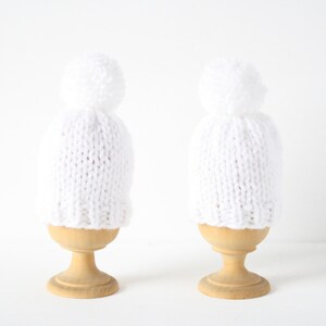 Set of two knitted egg cosies or egg warmers in pink, white, mustard, light green or taupe White