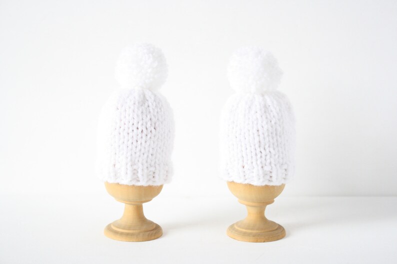 Set of two knitted egg cosies or egg warmers in pink, white, mustard, light green or taupe White