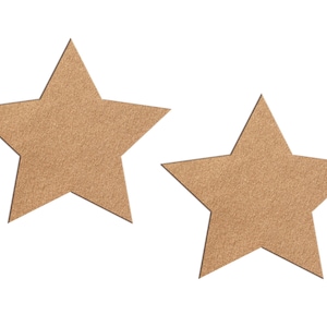 May include: Two tan-coloured star-shaped cutouts against a white background. The stars have a textured surface and are positioned slightly apart from each other. They are likely decorative elements.