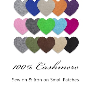 Peut inclure: Des patchs en forme de cœur en cachemire de différentes couleurs, dont le gris, le bleu et le beige. Les patchs sont conçus pour être cousus ou repassés sur du tissu. Le texte "100% Cashmere" et "Sew on & Iron on Small Patches" est également présent.