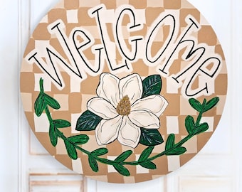 Letrero de puerta redondo de lona a cuadros con diseño de magnolia pintado a mano.