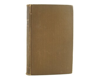 May include: A brown hardback book with a textured cover. The book is standing upright against a white background.