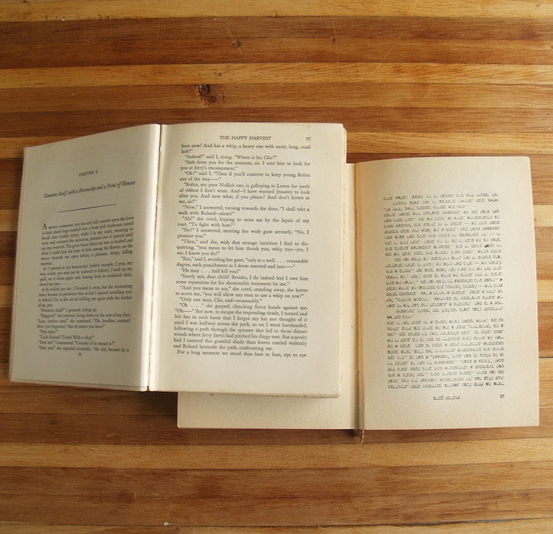 May include: An open book with a white background and brown text. The book is titled "The Happy Harvest" and the text reads "And has a whip, a heavy one with many, long, cruel  blows."
