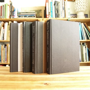 May include: Four hardback books with black covers and white text titles. The titles are "Moments in the Making", "David  the Simple Truth", "Lotte Lehmann", and "Alan  Jeffries".