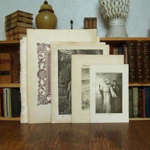 May include: A collection of five antique prints, each with a different image. The prints are framed in a simple, white frame. The prints are all in black and white and feature a variety of subjects, including a landscape, a portrait, and a religious scene. The prints are all in good condition and would make a great addition to any home.