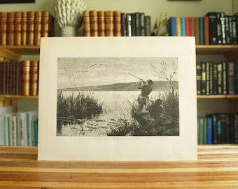 May include: A black and white illustration of two people hunting ducks on a lake. The people are standing in a marsh and one is aiming a rifle at a flock of ducks flying overhead. The text "Duck Shooting on Kankakee Lake" is printed below the image.