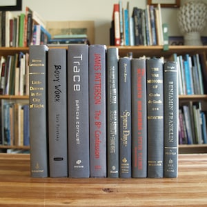 Collection of nine hardcover books with gray bindings - Free US Shipping