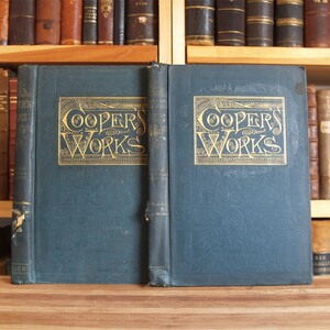 May include: Two blue hardcover books with gold lettering on the spine and front cover. The books are titled "Coopers Works".