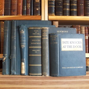 May include: A collection of vintage hardcover books with blue covers. The titles include "Louisiana and Russia", "State of New York Education Department", "Sermons by John E. Azleton", "Fate Knocks at the Door", and "Sermons".