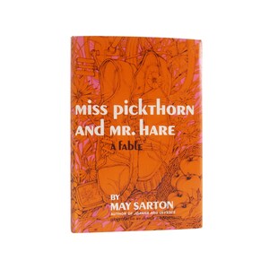 May include: An orange book cover with an illustration of shoes and apples. The title is "Miss Pickthorn and Mr. Hare: A Fable" by May Sarton.