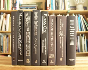 Collection of eight hardcover books in black bindings with silver lettering - Free US Shipping