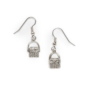 May include: Silver dangle earrings with a small basket charm.